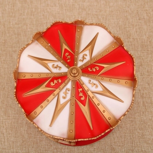 Top view of a festive red and gold musical carousel tent with intricate ornate details