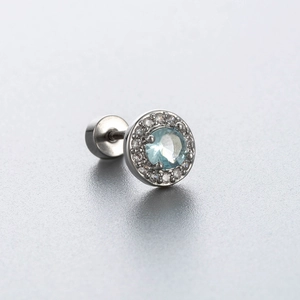 Titanium steel ear stud with blue zircon center and pavé crystals on gray background