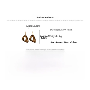 Detailed specs of triangle leopard resin earrings with gold studs and silver pins
