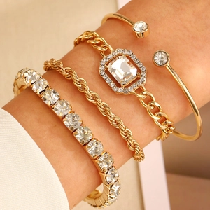Set of four vintage gold punk bracelets with twist chains and sparkling crystals