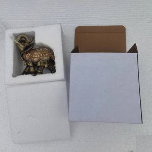 Southeast Asian resin elephant ornament in bronze and gold finish, top view display