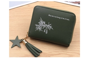 Detail of green mini wallet with leather texture star charm and green tassel decoration