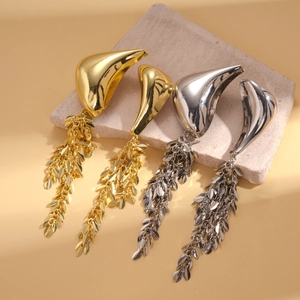 Detail of high-shine metallic water drop stud earrings with long layered tassels