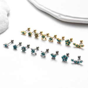 Detailed assortment of gold and silver surgical steel ear studs with turquoise stones