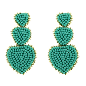 Bohemian turquoise beaded triple heart drop earrings with gold border on white background