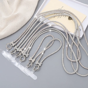 Close-up of sparkling rhinestone bow phone lanyards with silver alloy lobster clasps