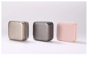 Three portable square jewelry organizers with zipper closure in champagne gold, gray, and pink