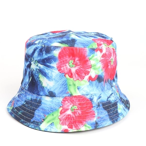 Detail of floral bucket hat showing precise stitching on blue fabric with red flowers