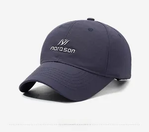 Detail shot of navy blue baseball cap showing textured quick-dry fabric and logo