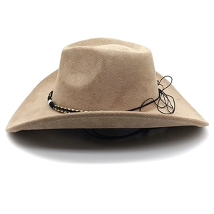 Detail view of khaki suede cowboy hat with braided band and chin strap on white background