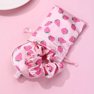 Pink silk eye mask set with strawberry print including scrunchie and storage bag