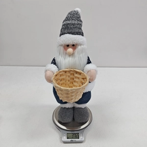 Close-up showing the 376.5g weight of a Christmas gnome figurine with a wooden basket