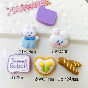 Macro shot of assorted resin charms including rabbit and heart shapes with precise dimensions
