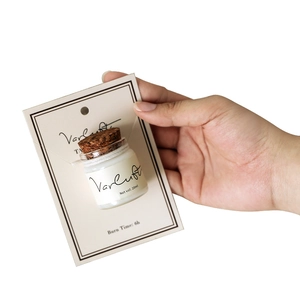 Mini 20ml scented candle in glass jar with cork lid and beige backing card display