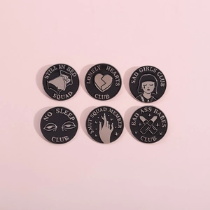Set of six creative black enamel pins featuring retro club themes on pink background