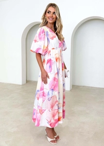 Deep V-neck floral maxi dress with watercolor print and puff sleeves in elegant setting