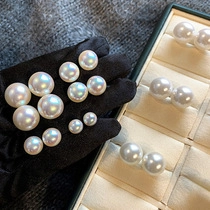 Macro detail of high-luster white pearls with iridescent finish on black velvet surface