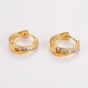 Detail view of gold crisscross hoop earrings with pavé cubic zirconia inlay settings