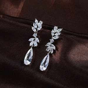 Sparkling waterdrop zircon drop earrings with S925 silver pins on brown silk fabric
