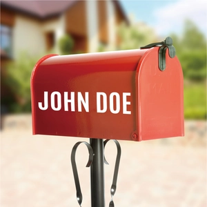 Detail of red American style mailbox with custom John Doe name and black bracket