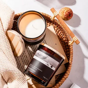 Aromatherapy soy wax candle in glass jar with wooden lid on a cozy knit blanket