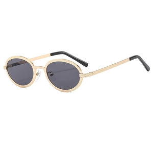 Vintage small oval steampunk sunglasses with textured golden metal frame and gray lenses