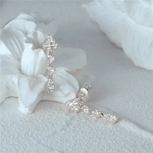 Macro view of floral s925 silver earrings with sparkling teardrop-cut cubic zirconia