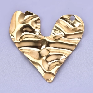 Macro shot of 304 stainless steel gold heart pendant with textured hammer finish