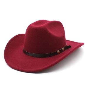 Detailed close-up of wool fedora with brown leather band and gold metal buckle accents