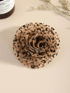 Detailed macro view of a leopard print gauze rose brooch with soft layered fabric texture