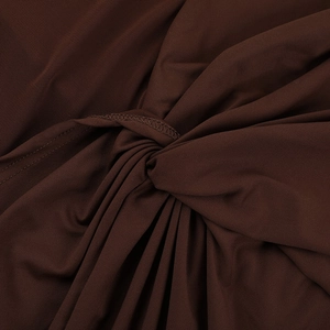 Detail of dark brown mesh stitching with twisted fabric texture on long sleeve dress