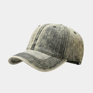 Detail of vintage washed yellow-green baseball cap with acid-wash texture and reinforced brim