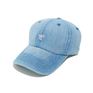 Detail of light blue denim baseball cap with pink bow embroidery and reinforced brim