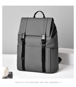 Close-up of matte waterproof fabric and plastic buckle on dark grey business laptop backpack
