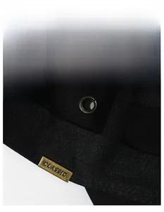 Detail of black sports cap featuring wide sweatband, metal eyelets and classic logo