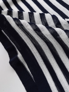 Detailed close-up of navy and white striped knit fabric showing texture and soft drape