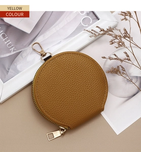 Macro shot of yellow lychee texture leather mini coin purse with metal zipper and hook