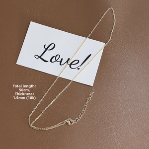 Macro detail of 18k gold-plated 1.5mm flat O-chain necklace with 50cm length scale