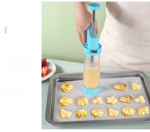 Sky blue cookie press gun kit with clear barrel showing dough for DIY baking