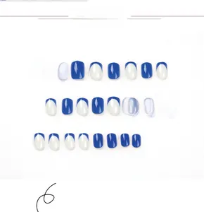 Flat lay detail of 24pcs blue french tip press-on nail kit with high-gloss finish