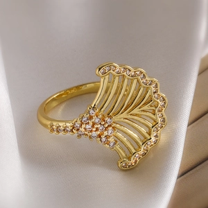 Detailed view of 18K gold plated ginkgo leaf ring with sparkling zircons on white silk