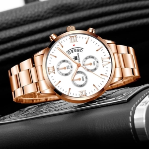 Detail of rose gold quartz watch with Roman numerals and three-eye chronograph display