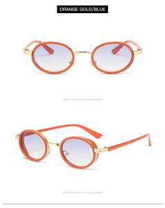 Detail view of oval sunglasses with orange gold frames and blue gradient lenses
