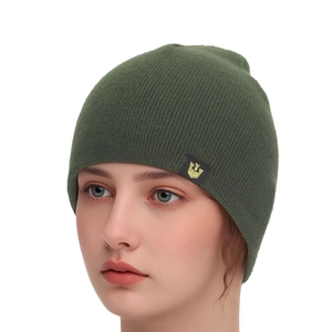 Detail of dark green knit beanie featuring a gold crown embroidery patch for winter