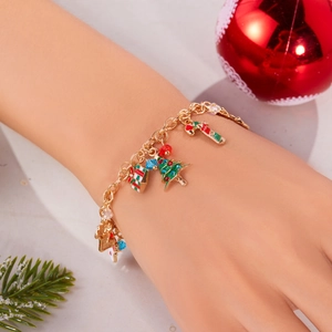 Detail of Christmas bracelet with Santa, reindeer, and tree charms on a gold chain