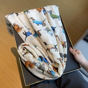 Detail of dachshund print on beige cotton-linen scarf with delicate frayed edge finish