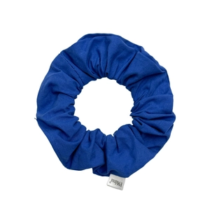 Blue cotton fabric scrunchie with chic solid color design on a clean white background