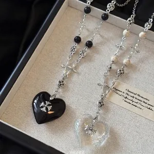 Gothic beaded necklace with heart pendants and silver floral cross charms in black and white