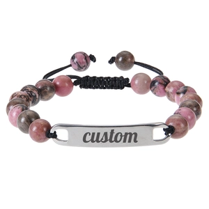 Detail of custom engraved metal bar on pink zebra stone beaded adjustable bracelet