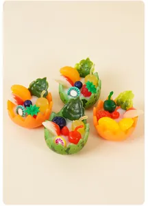 Overhead view of various miniature fruit salad bowls with strawberries and blueberries